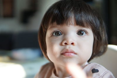 Portrait of cute baby girl at home