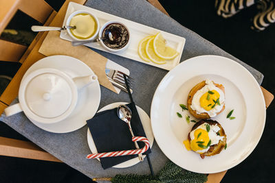 Flat lay photo of breakfast in the room, there is a benedict egg on the table