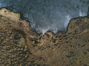 Aerial view of land by sea