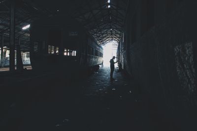 Silhouette of man standing at shunting yard