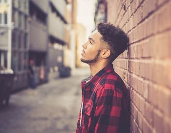 Side view of young man standing outdoors