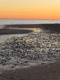 Scenic view of beach against sky during sunset