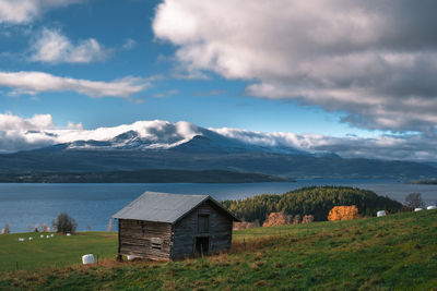 House on mountain against sky