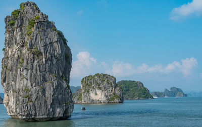 Scenic view of rock formation in sea against sky