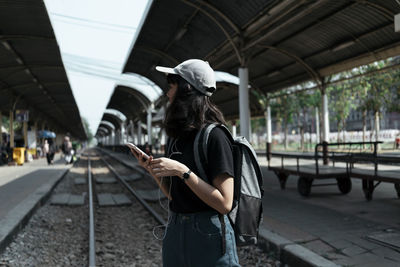 Man using mobile phone while standing on city street