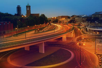 Night traffic light trails created by vehicles moving on two-level flyover - long exposure