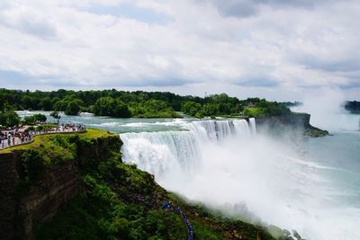 Scenic view of waterfall against sky