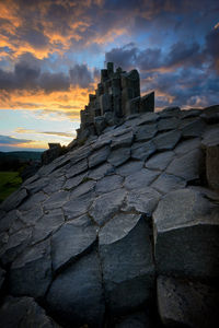 Low angle view of old ruin against sky during sunset