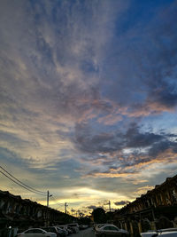 Low angle view of city against sky at sunset