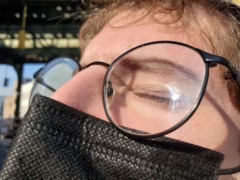 Close-up of man with reflection on glass