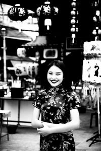 Portrait of young woman standing outdoors