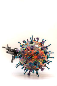 Close-up of colored pencils on table against white background