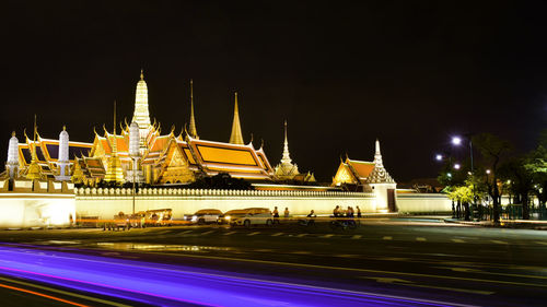 Illuminated building against sky at night