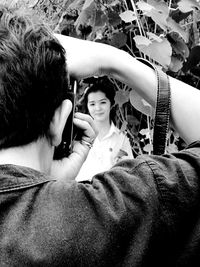 Rear view of woman photographing