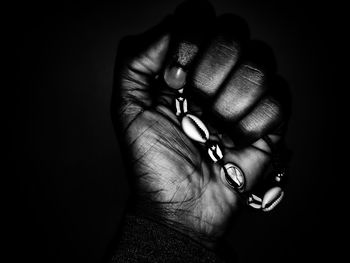 Close-up of woman hand holding black background