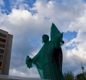 Low angle view of statue against cloudy sky