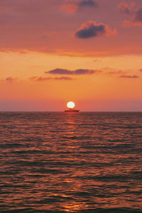 Scenic view of sea against orange sky