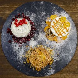 Directly above shot of desserts on slate over table