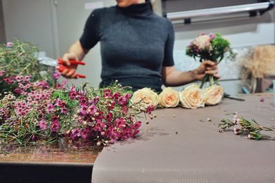 Midsection of florist standing at table