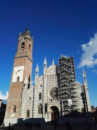 Low angle view of bell tower against blue sky