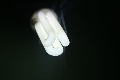 Close-up of light bulb against black background