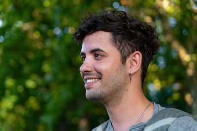 Portrait of young man looking away outdoors