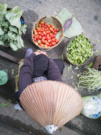 High angle view of man holding vegetables in market