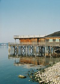 Pier over sea against clear sky