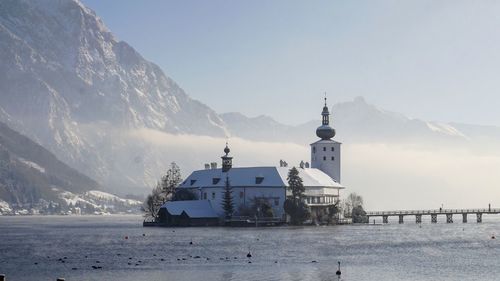 Castle in lake surrounded with mountains