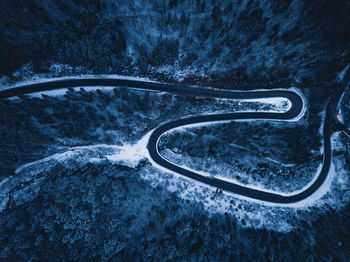 Aerial view of winding road in forest