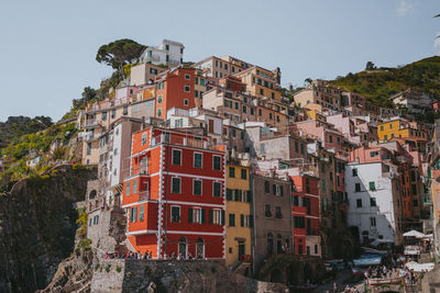 Buildings in city against clear sky