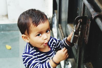 High angle view of cute baby girl opening gate