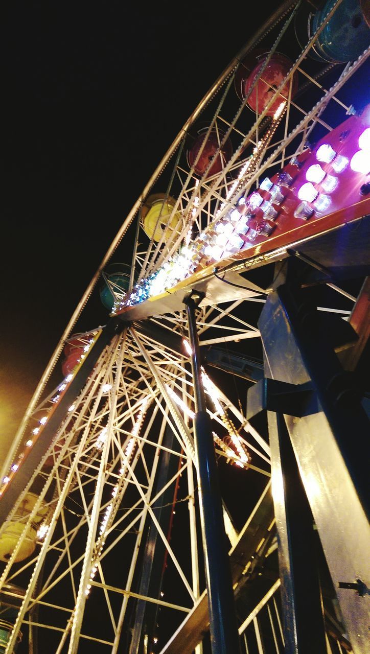 LOW ANGLE VIEW OF ILLUMINATED FERRIS WHEEL AT NIGHT