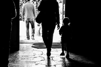 Rear view of people walking on street