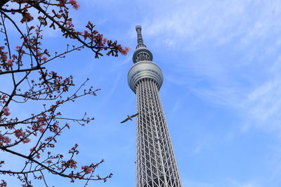 Low angle view of communications tower against blue sky