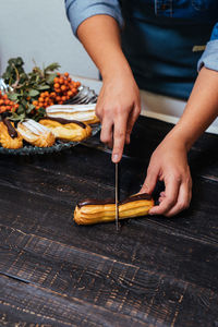 Midsection of man preparing food on table