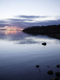 Scenic view of lake against sky at sunset