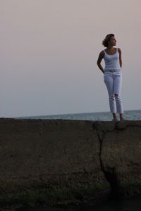 Full length of woman standing on land against sky