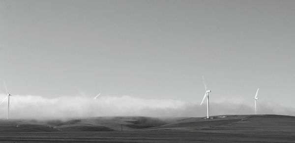 Windmill on field against sky