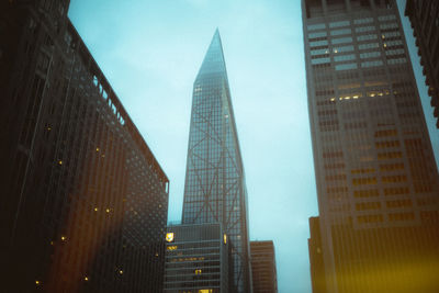 Low angle view of skyscrapers against sky at night