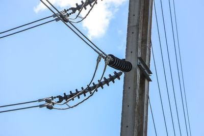 Low angle view of electricity pylon against sky