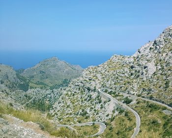 Scenic view of mountains against clear blue sky