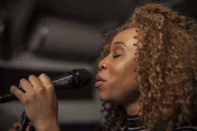 Singer performing in a recording studio