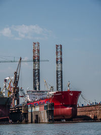 Commercial dock by sea against sky