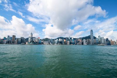 Panoramic view of sea and buildings against sky