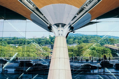 High angle view of airport with trees reflecting on windows