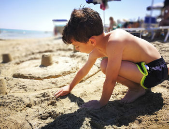 Side view of boy on beach