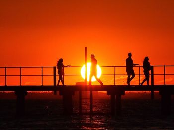 Silhouette of people at sunset