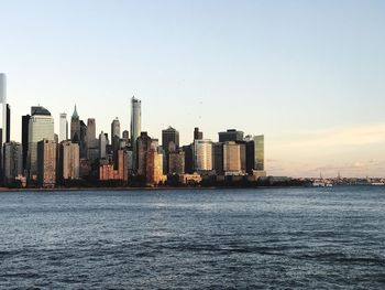 Illuminated cityscape against clear sky