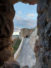 View of rock formation against cloudy sky